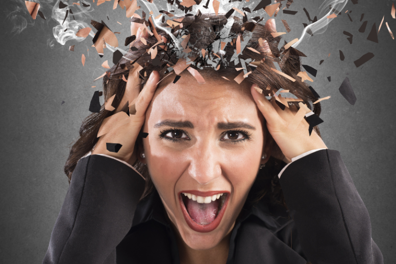 Woman clutching her head due to feeling stressed